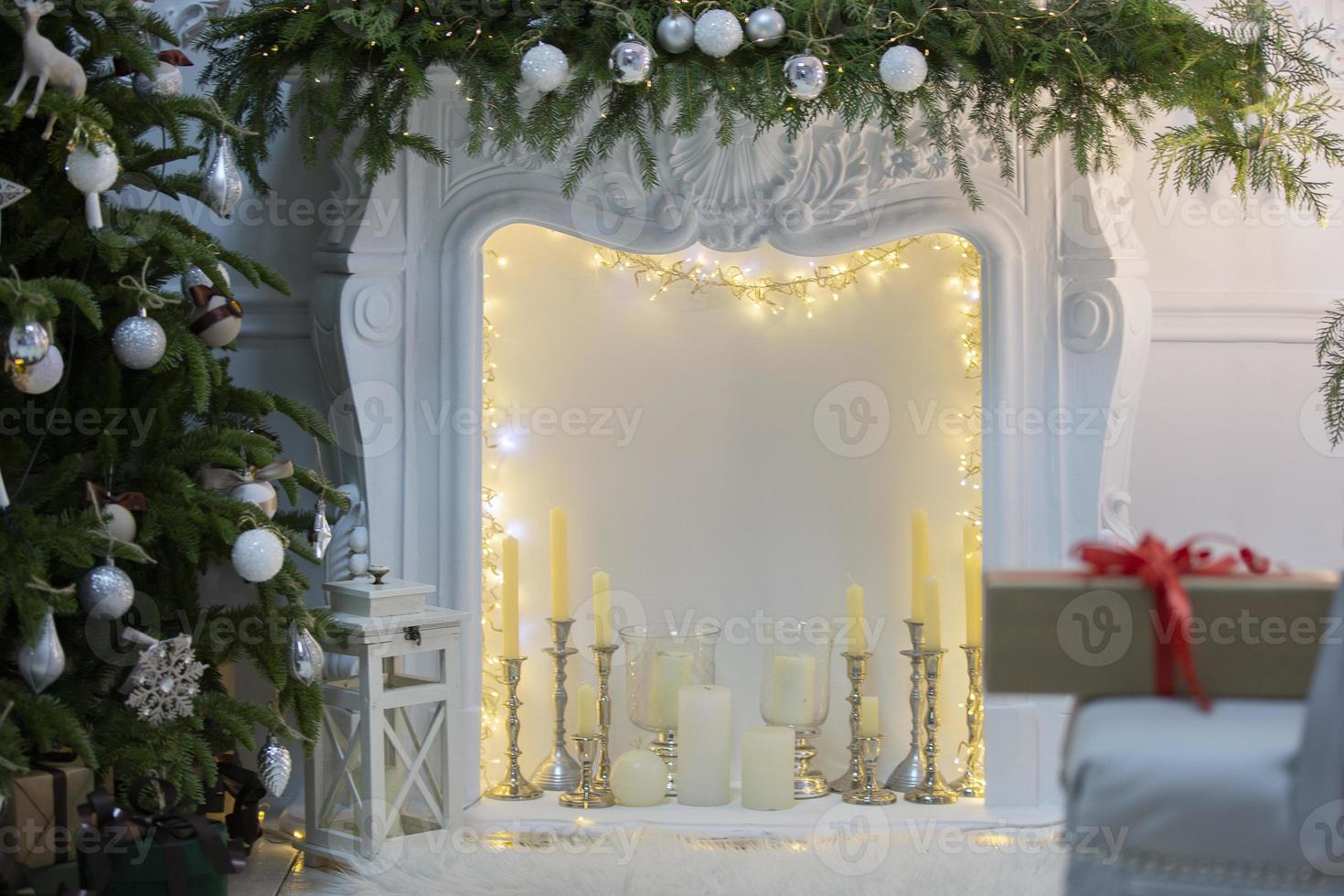 Beautiful Christmas interior of a room or photo studio with a Christmas tree and a fireplace.