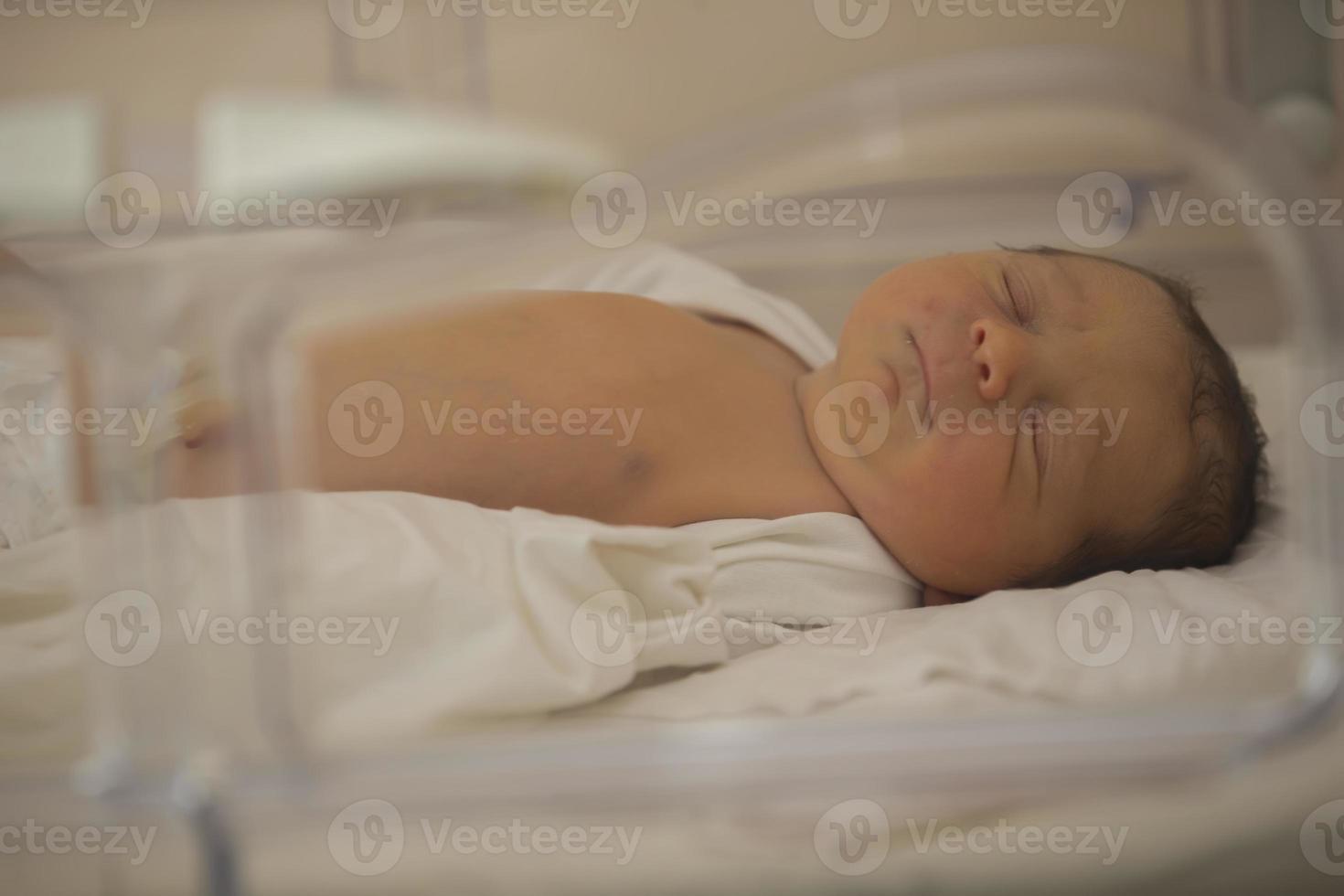 Neonatology. A newborn in a special incubator for babies in a hospital. photo
