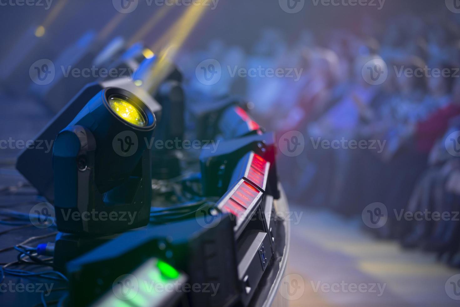Light from stage lights against the background of blurry spectators. photo