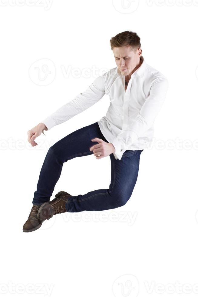 A man effectively jumps up on a white background. photo