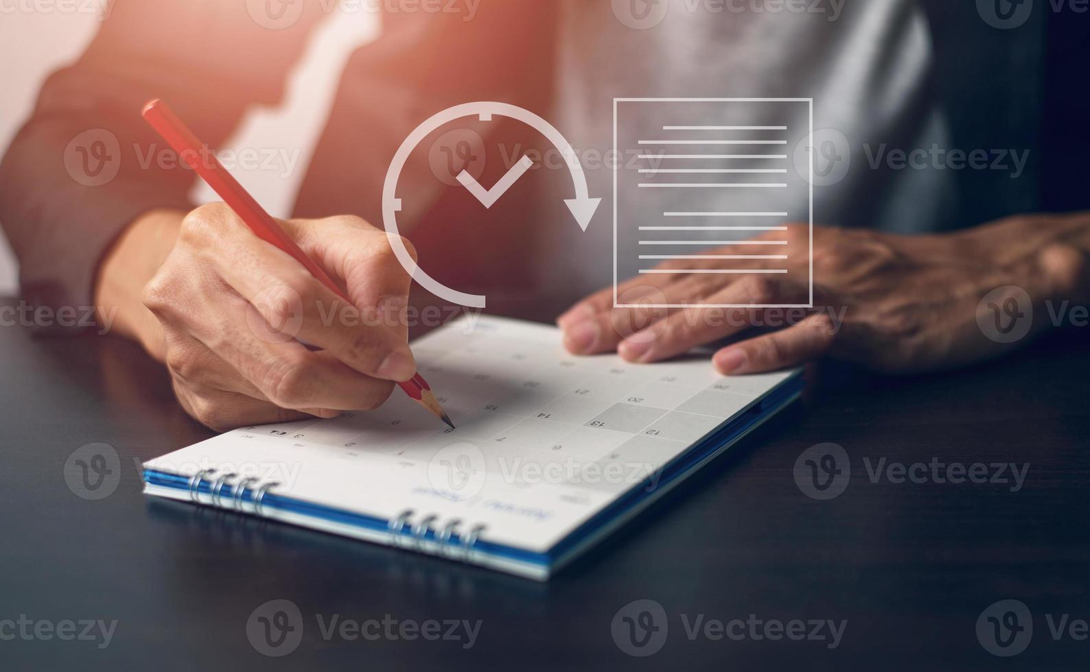 Male office worker looking at calendar appointments photo