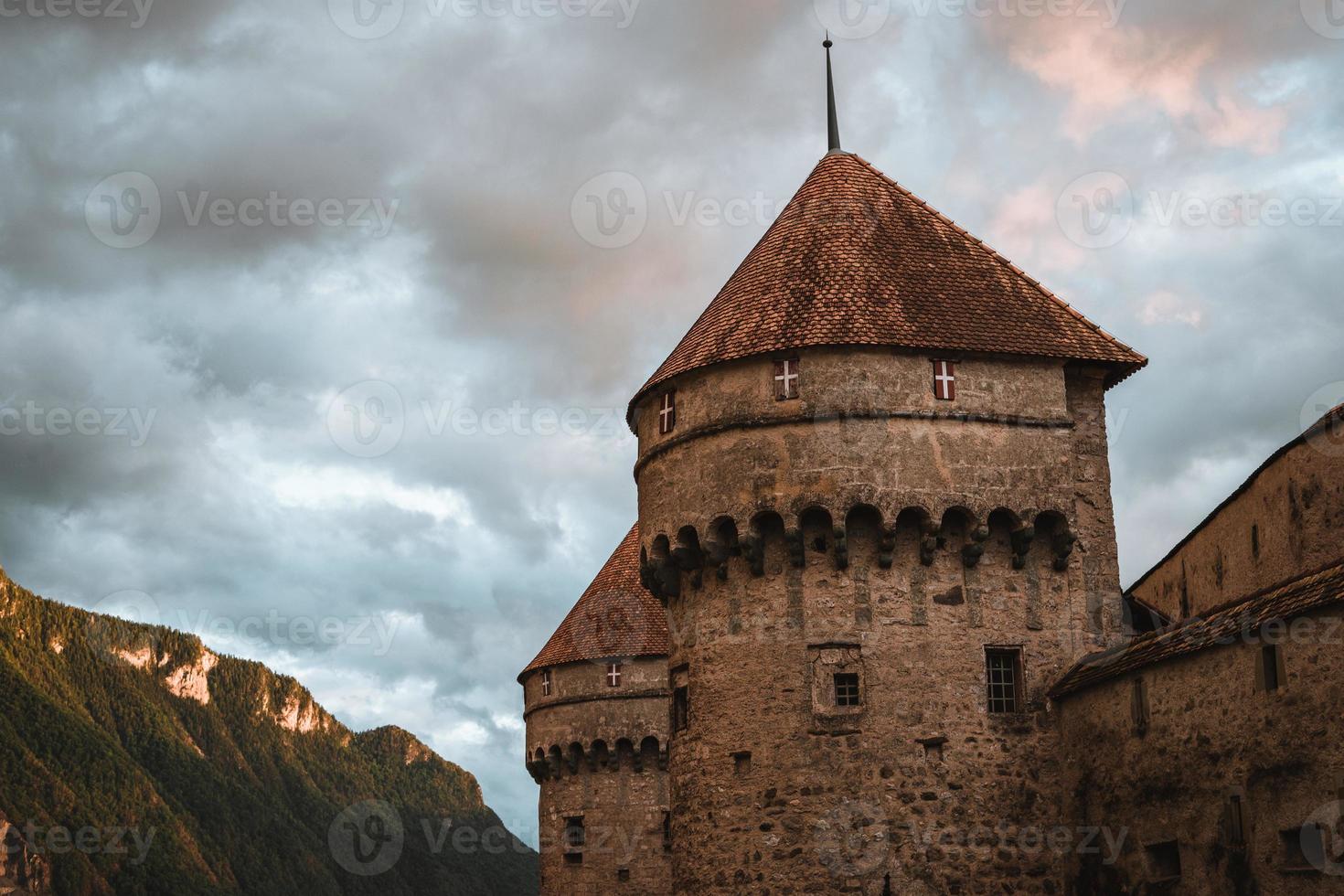 Chillon Castle on Lake Geneva during sunset photo