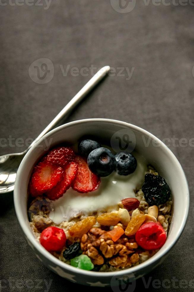 Breakfast oatmeal with fruits and nuts photo