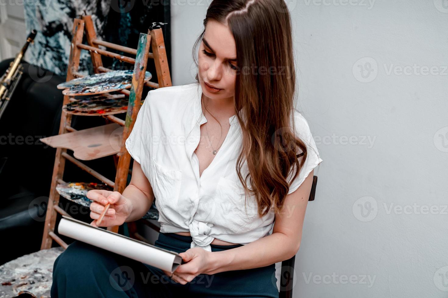 the artist is working on a painting draws a sketch in the workshop photo