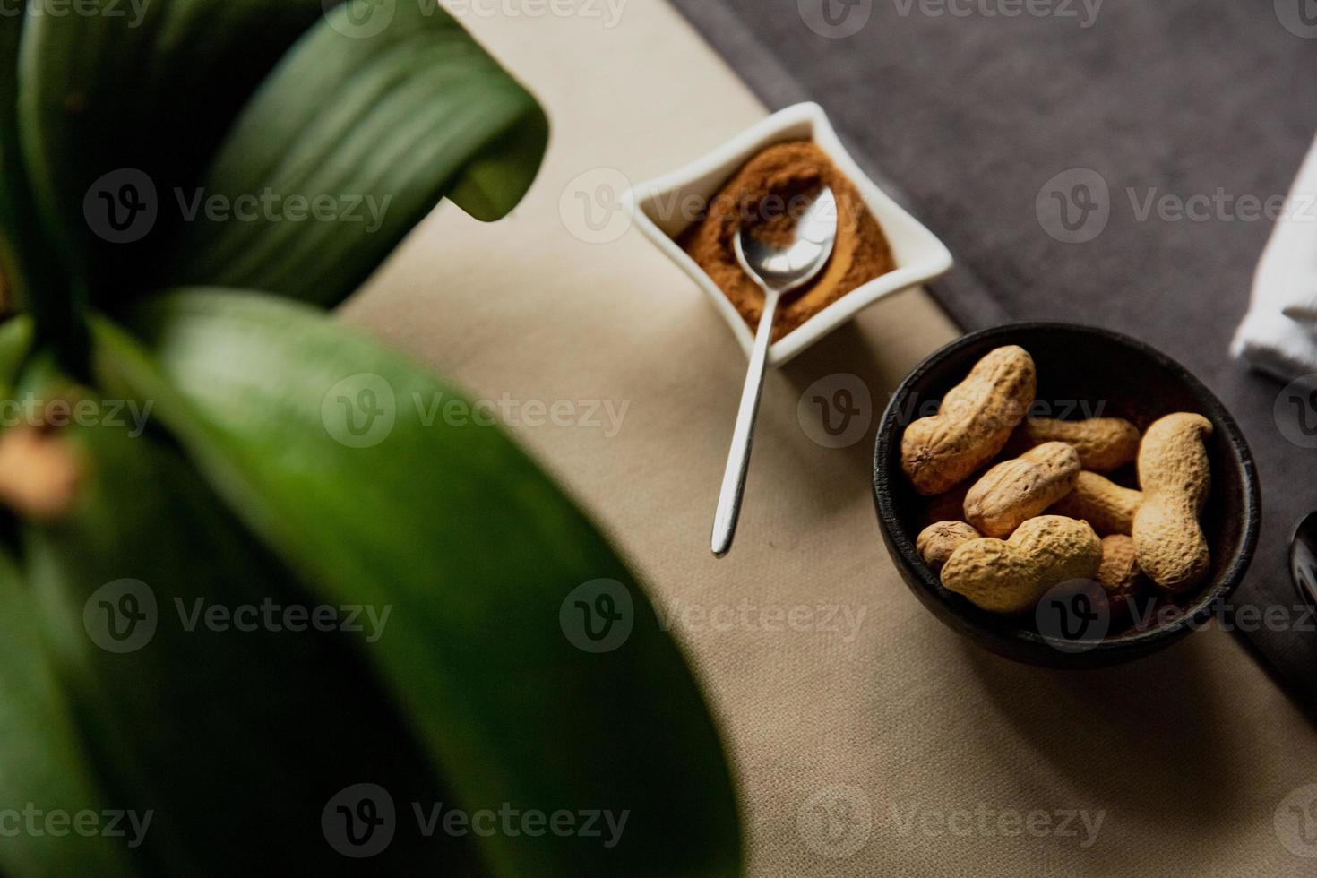 Pistachios in a wooden dish on the table photo