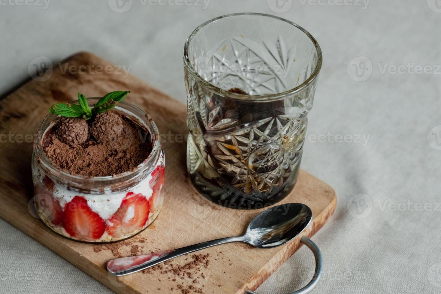 frozen coffee in a faceted glass, tiramisu with strawberries photo