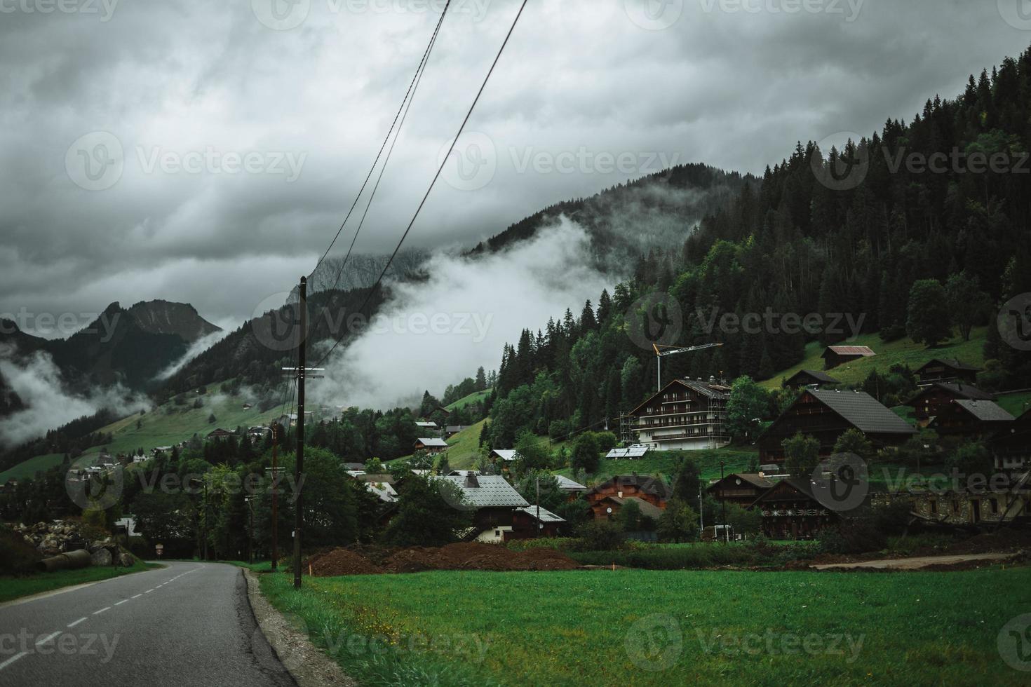 Majestic mountains in the Alps covered with trees and clouds photo