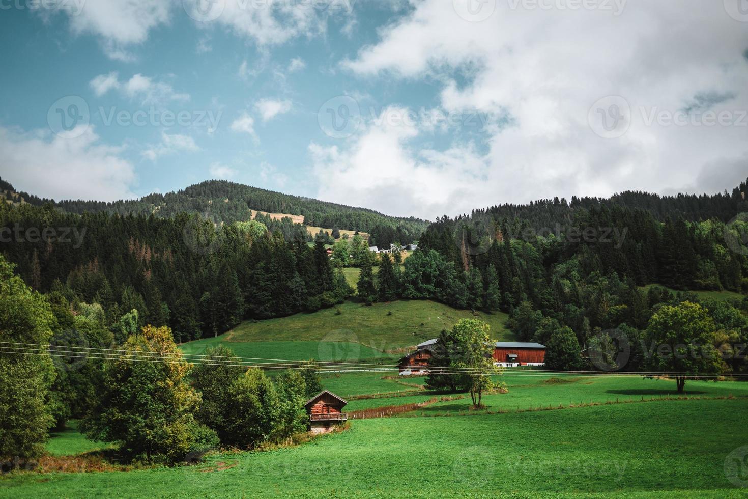 Majestic mountains in the Alps covered with trees and clouds photo