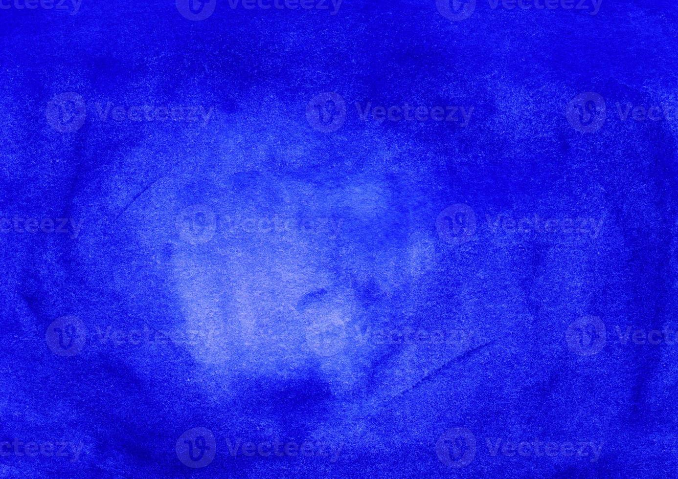 Watercolor dark blue background with space for text. Stains on paper photo