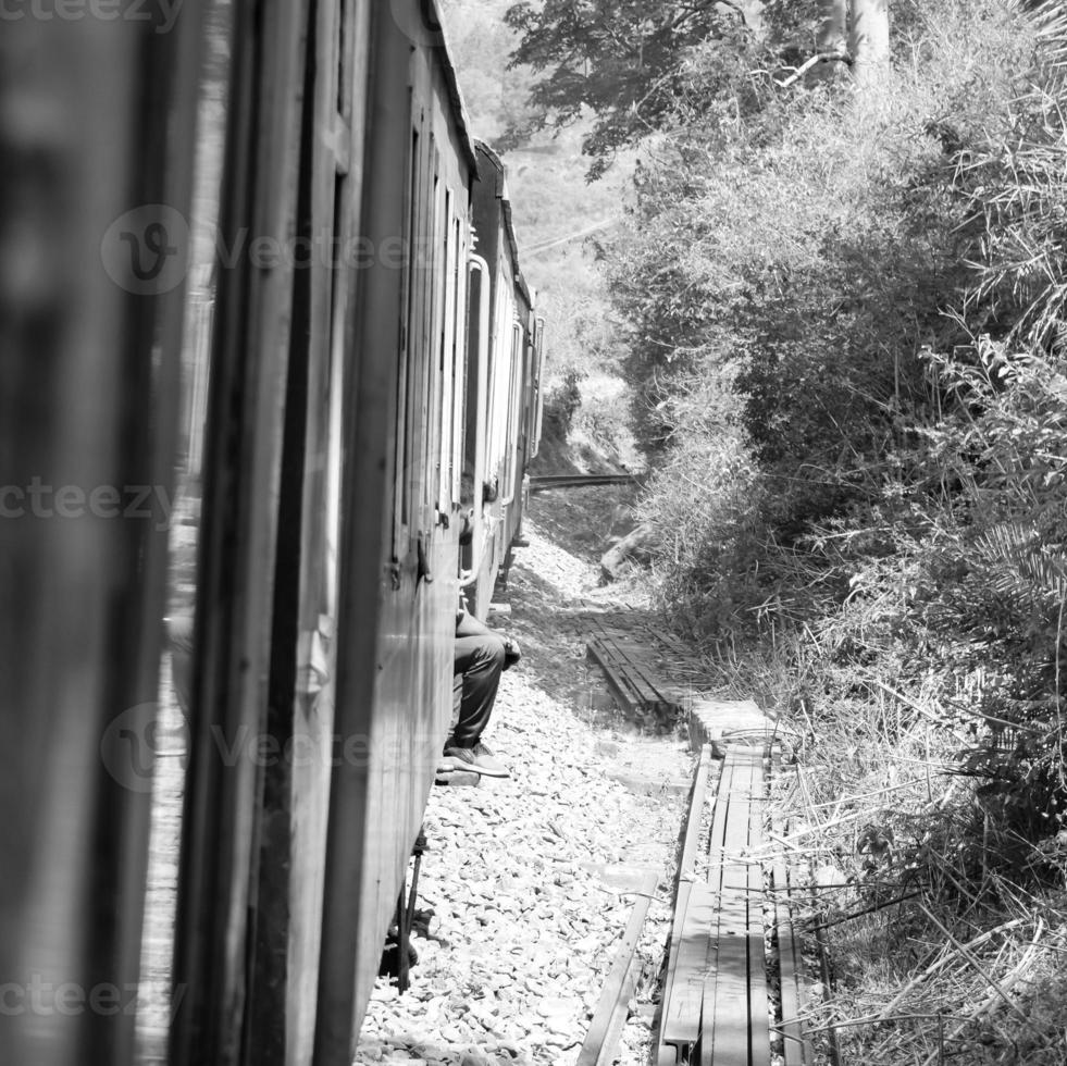 Toy Train moving on mountain slope, beautiful view, 1 side mountain, 1 side valley moving on railway to the hill, among green natural forest. Toy train from Kalka to Shimla in India-Black and White photo