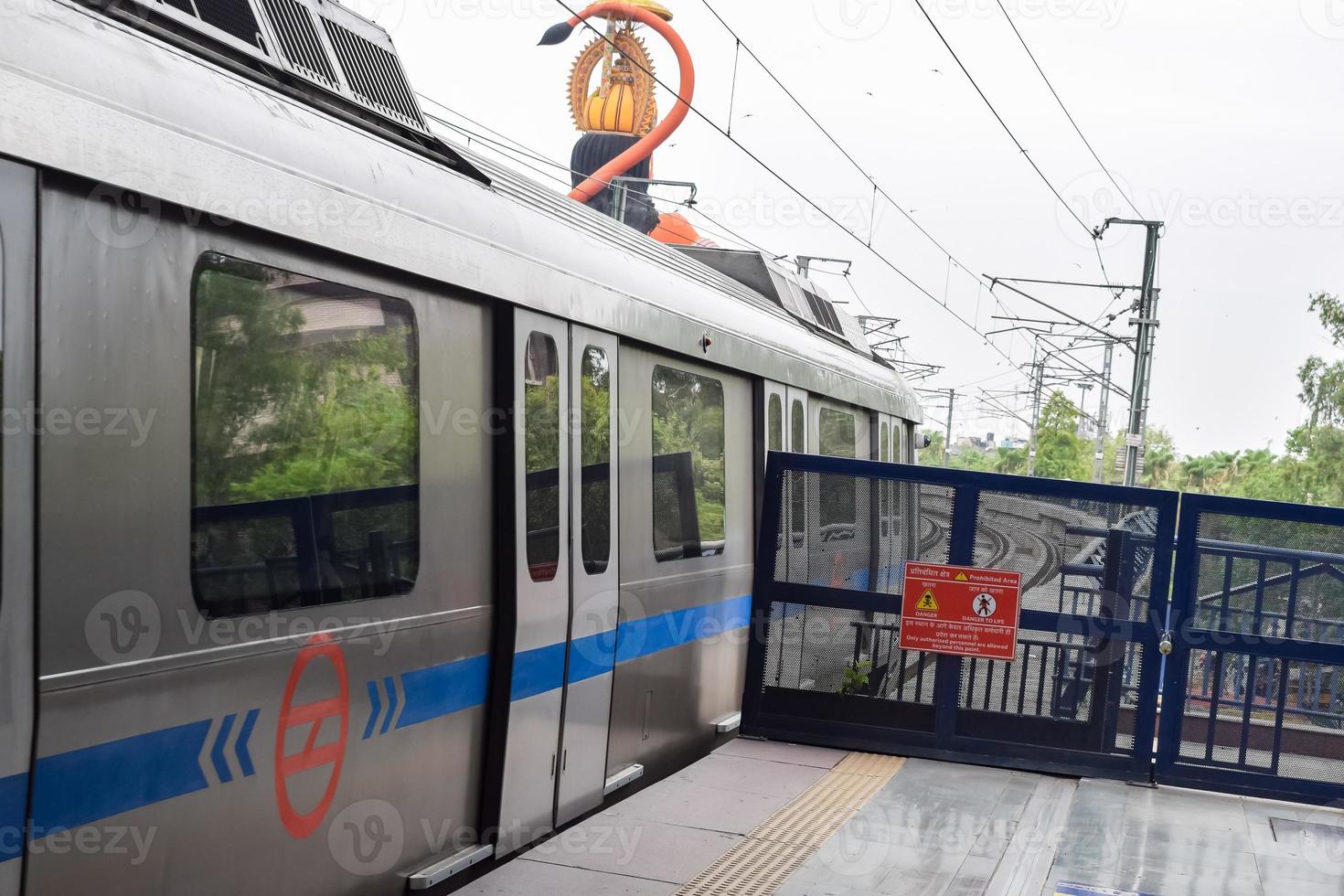 New Delhi India - June 21 2022 - Delhi Metro train arriving at Jhandewalan metro station in New Delhi, India, Asia, Public Metro departing from Jhandewalan station photo