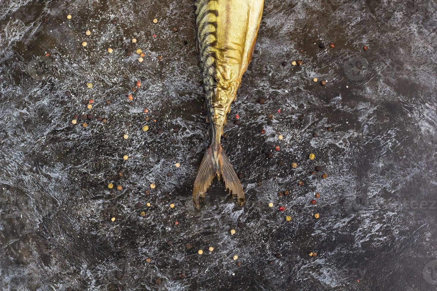 Smoked mackerel without head on black background. copyspace top view photo