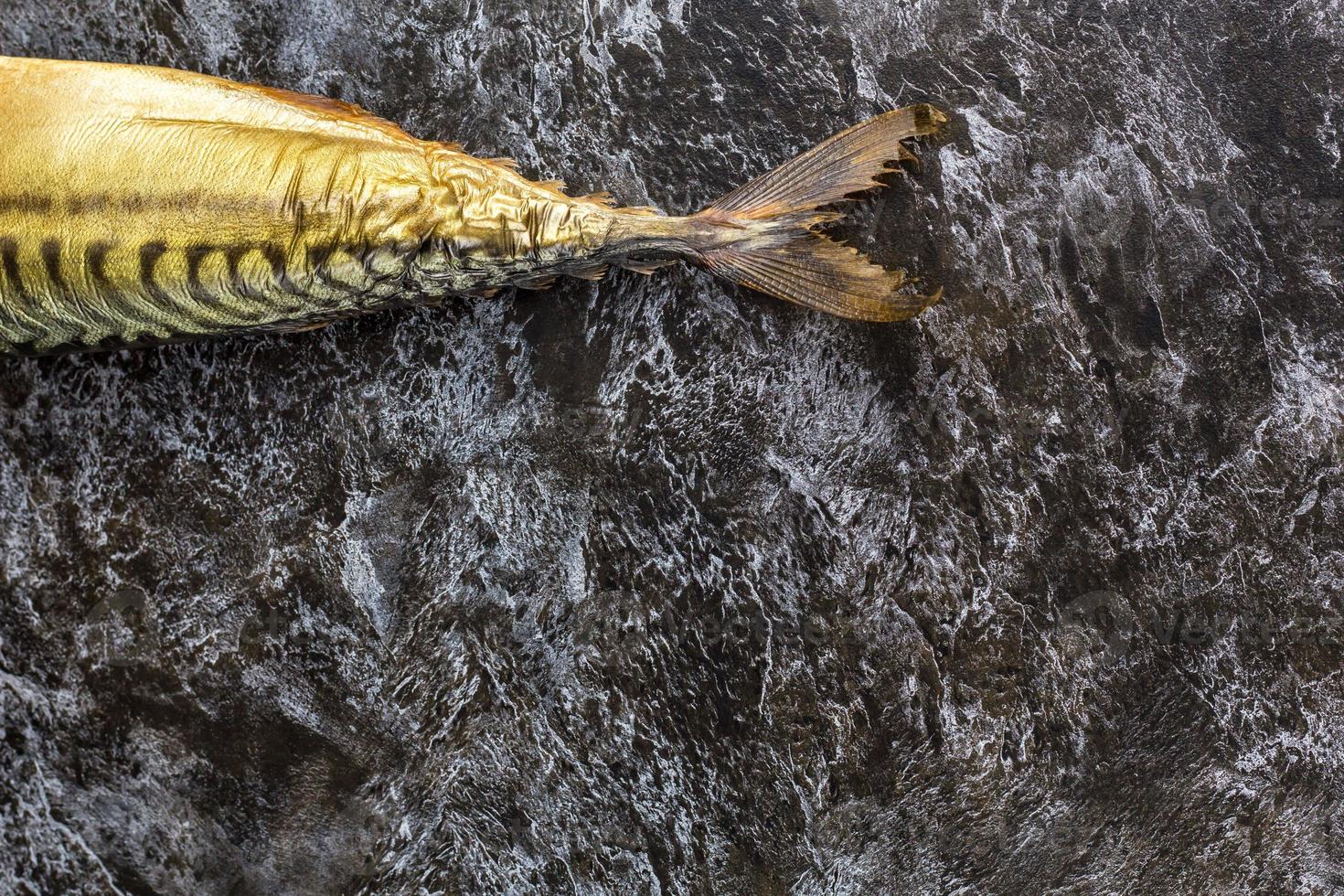 Smoked mackerel without head on black background. copyspace top view photo