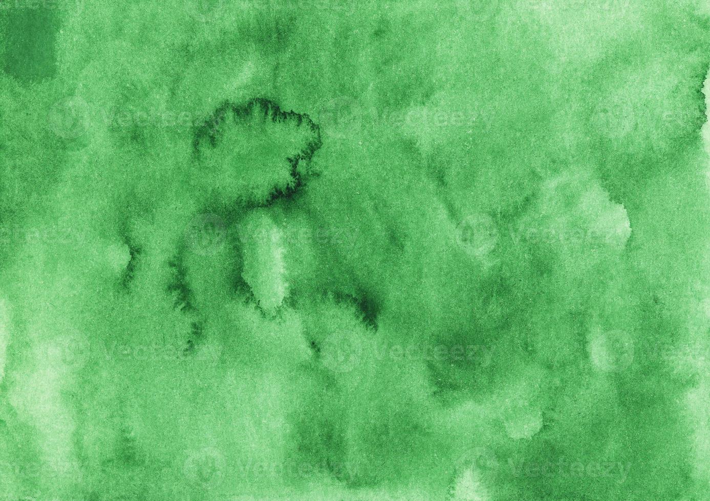 Watercolor green background texture. Aquarelle emerald color backdrop. Stains on paper photo