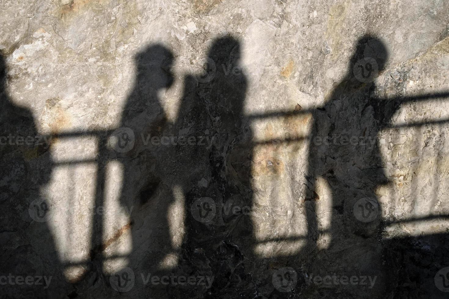 Shadow of a crowd of people on a cliff photo