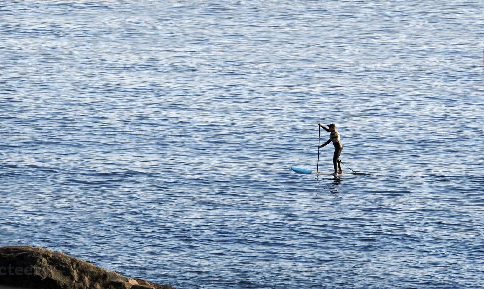 Stand up paddle at the coast of Enoshima, Japan photo