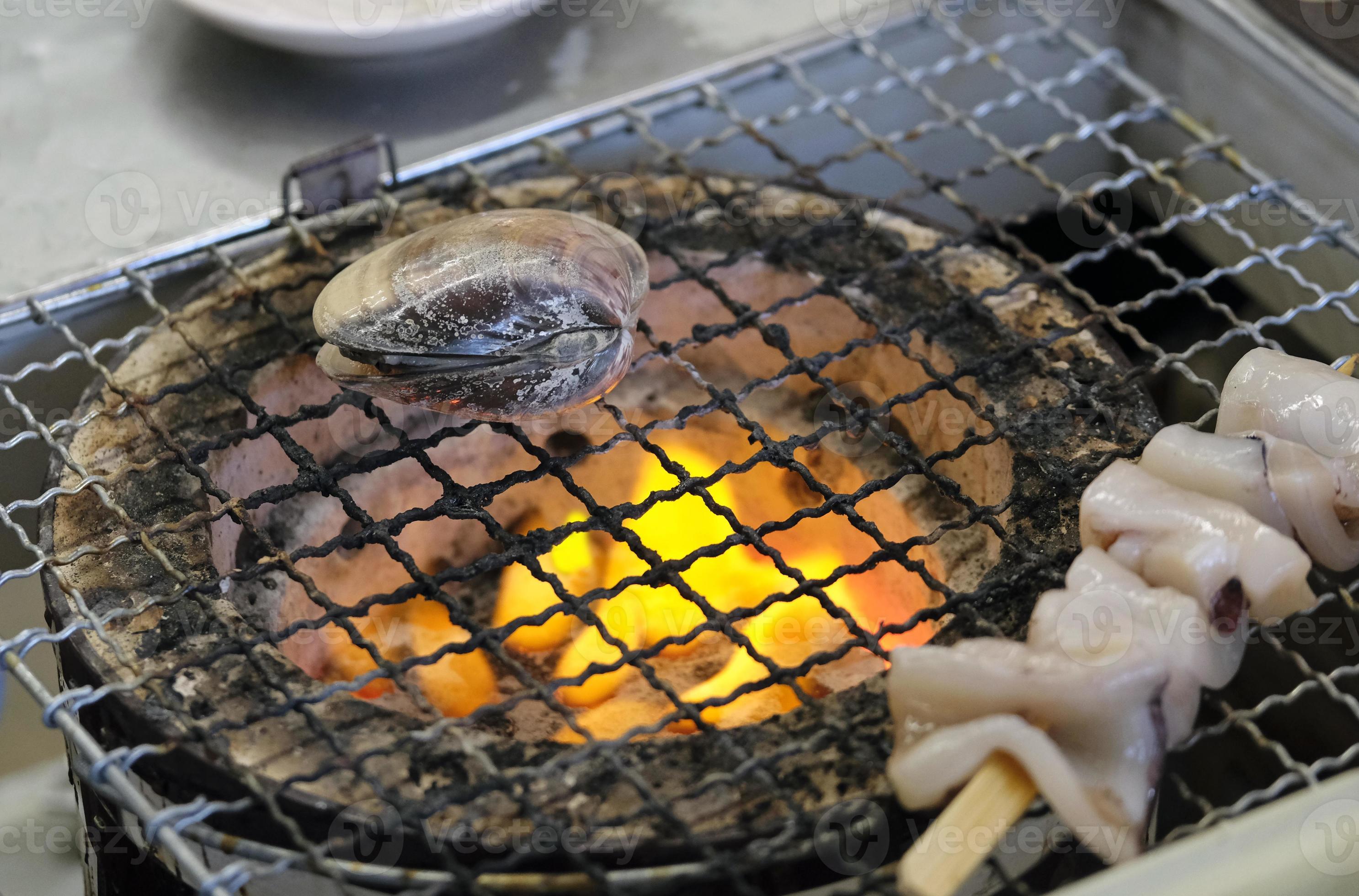 Closeup of mussels and other seafood on a grill in Enoshima, Japan