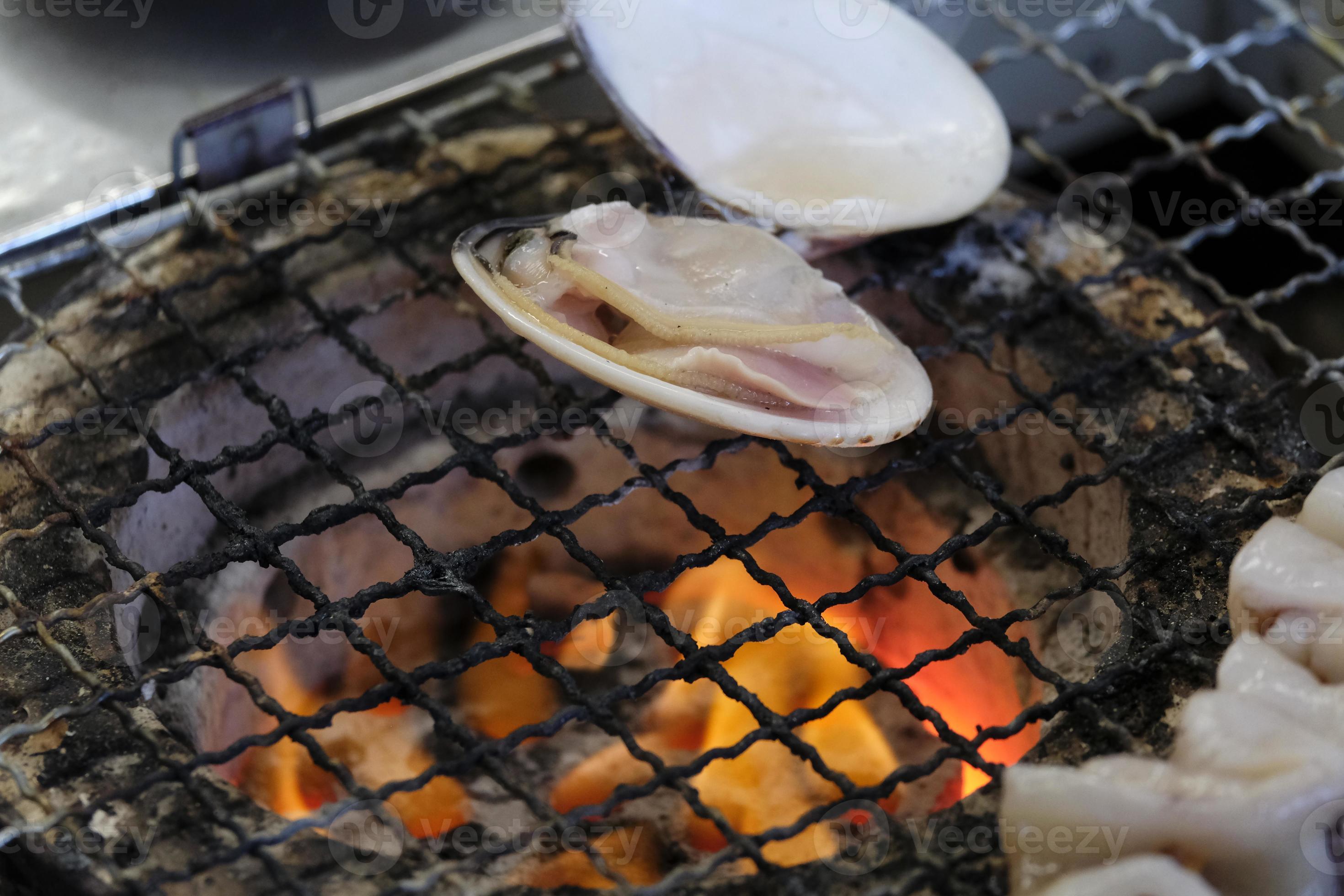 Closeup of mussels and other seafood on a grill in Enoshima, Japan