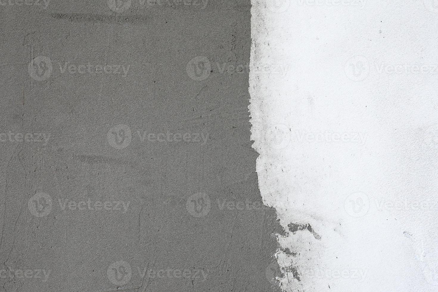 gray and white plaster wall surface for texture or backgrounds photo