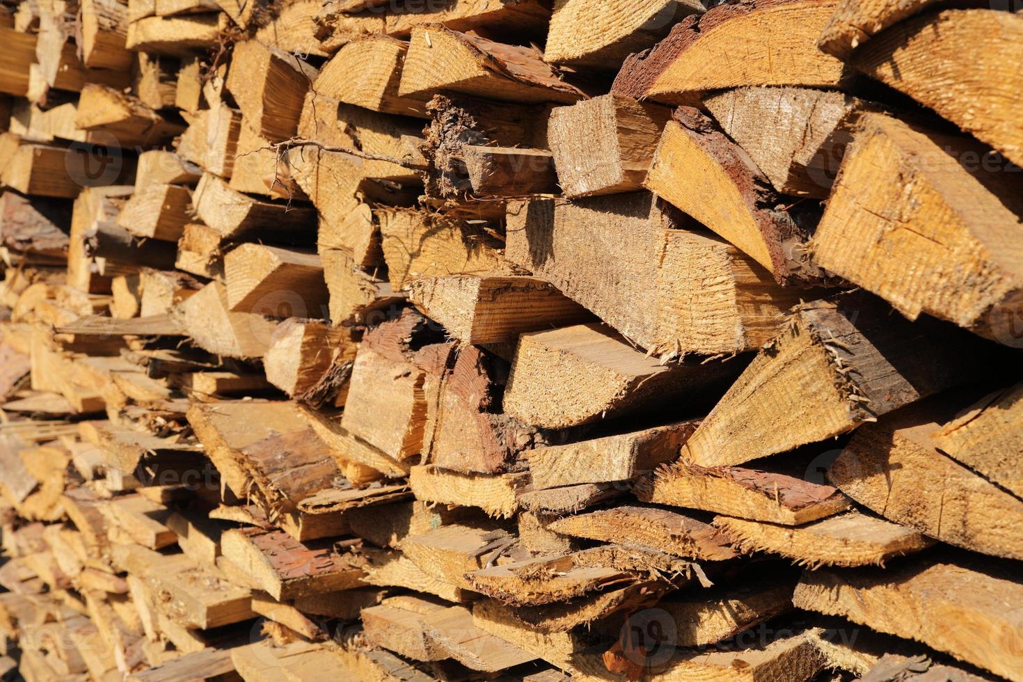 texture of pine firewood. Chipped firewood is on the heap. Woodpile of firewood close-up. A stack of dry firewood, visible texture and cracks in the tree. selective focus. photo