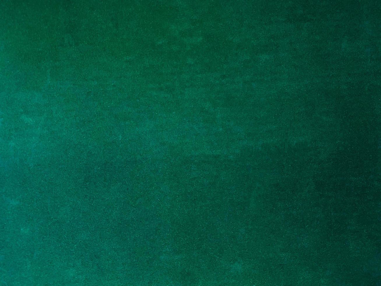 Dark green old velvet fabric texture used as background. Empty green fabric background of soft and smooth textile material. There is space for text. photo