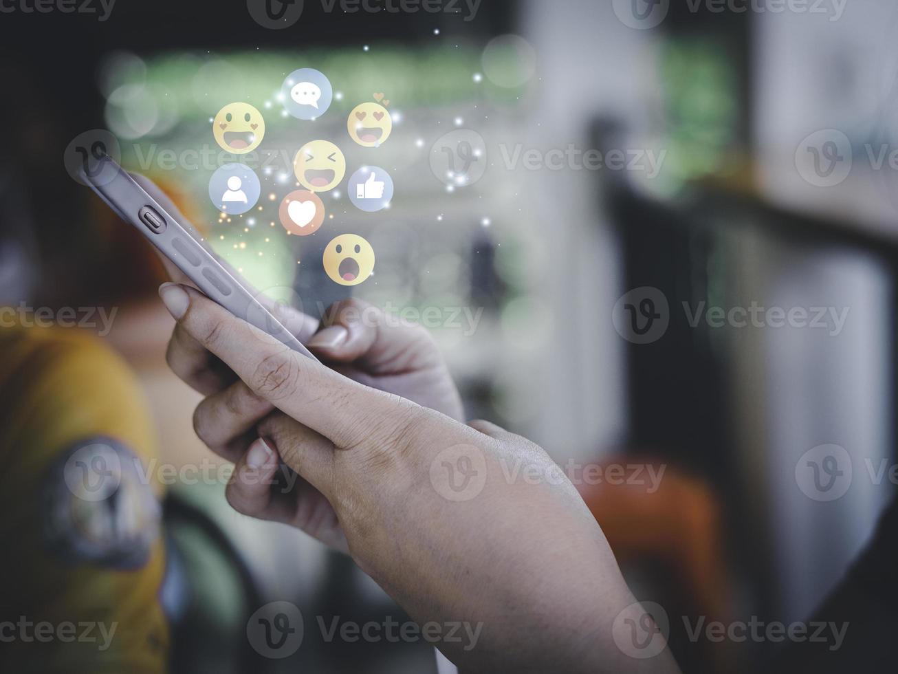 Concept with notification icons of like being happyand social media interactions on mobile phone,message, email, comment ,businessman hands holding device photo