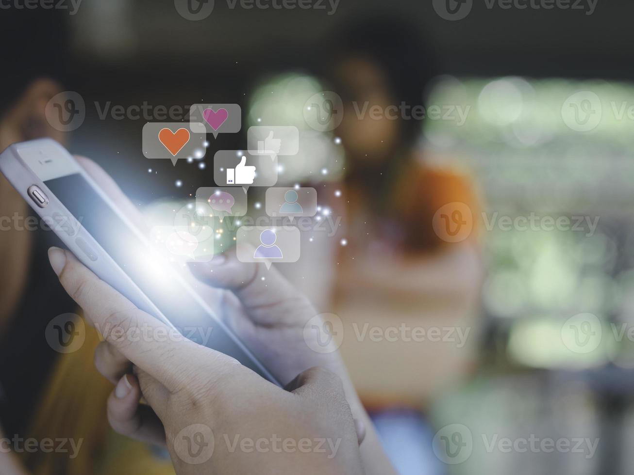 Concept with notification icons of like being happyand social media interactions on mobile phone,message, email, comment ,businessman hands holding device photo