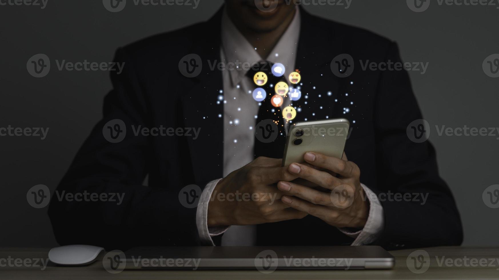 Concept with notification icons of like being happyand social media interactions on mobile phone,message, email, comment ,businessman hands holding device photo