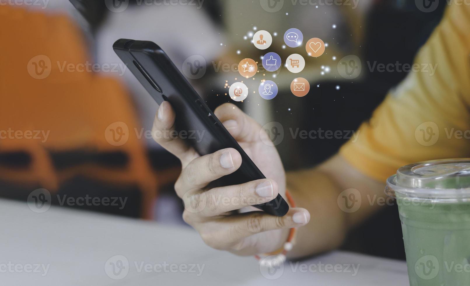 Concept with notification icons of like being happyand social media interactions on mobile phone,message, email, comment ,businessman hands holding device photo