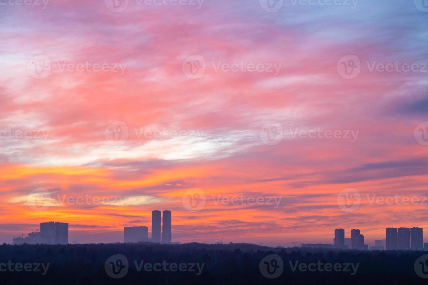 colorful cloudscape over city park and towers photo