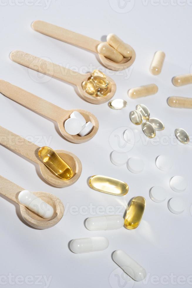 Spoons with vitamins, Vitamin D, omega 3, omega 6, Food supplement oil filled fish oil, vitamin A, vitamin E, flaxseed oil photo