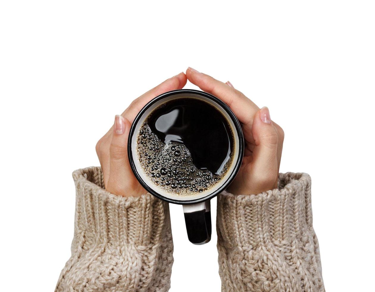 Woman holding cup of hot coffee isolated on white, closeup photo of hands in warm sweater with mug, winter morning concept, top view