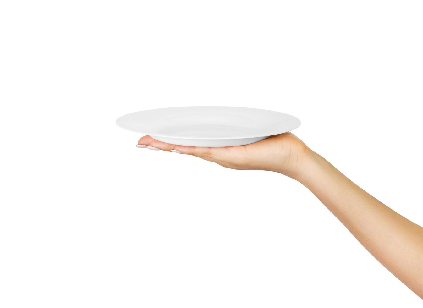 Blank empty round plate in female hand. perspective view, isolated on white background photo