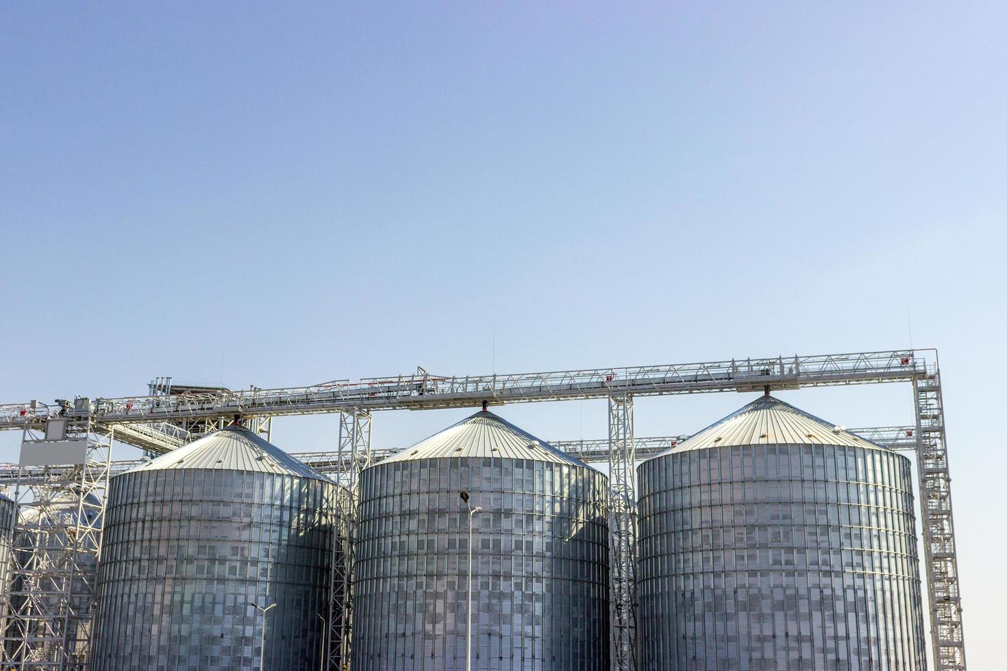 Cereal silos under the blue sky. Industrial storage. photo