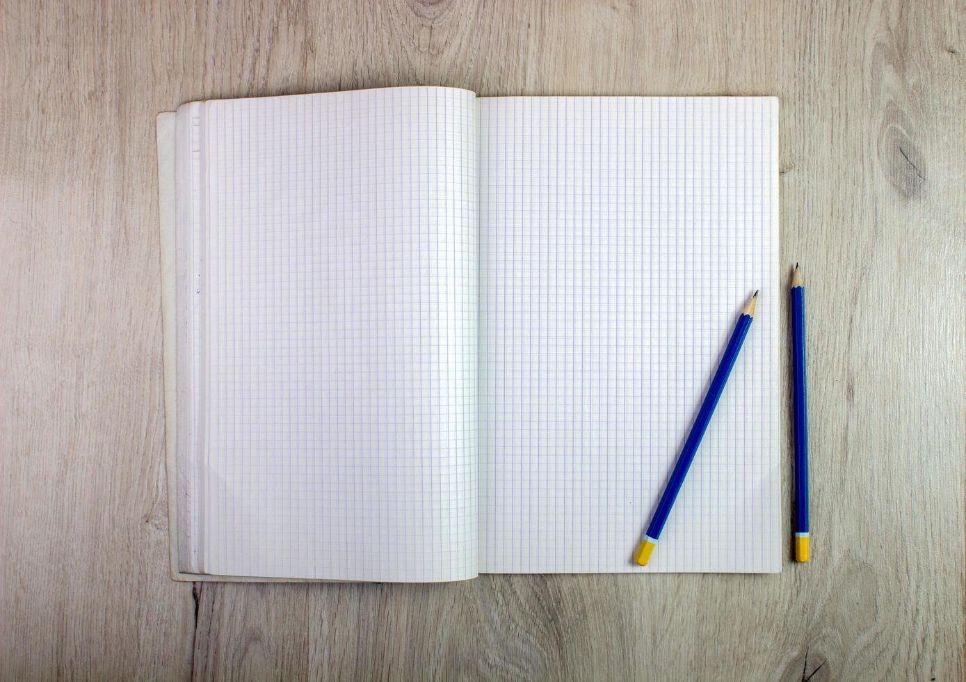 Notepad and pencil on wood table photo