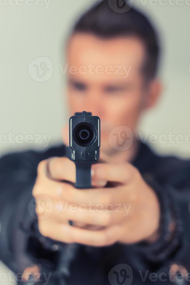 Close up of man aiming with handgun. photo