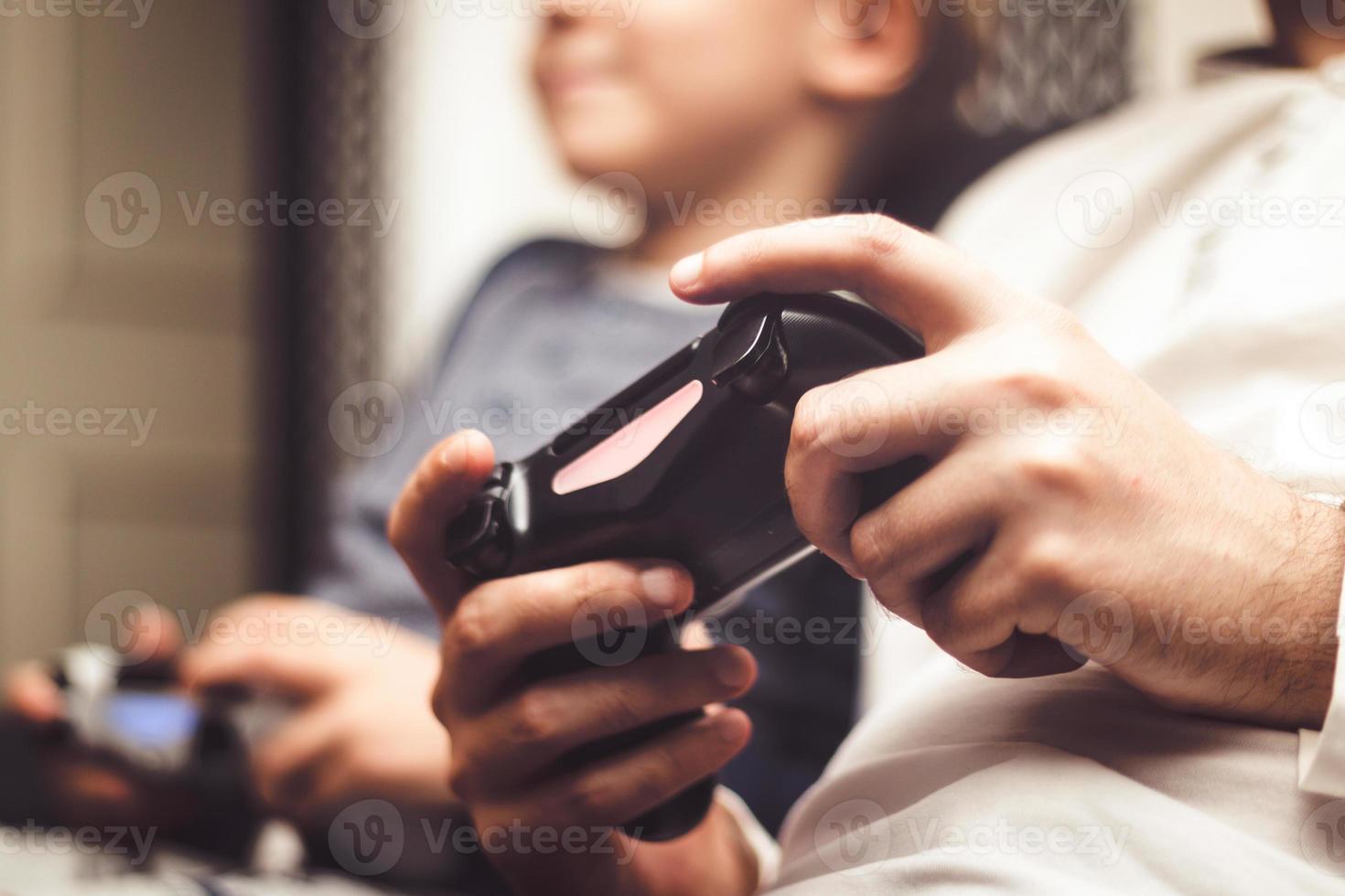 Close up of playing video game with wireless game controller. photo