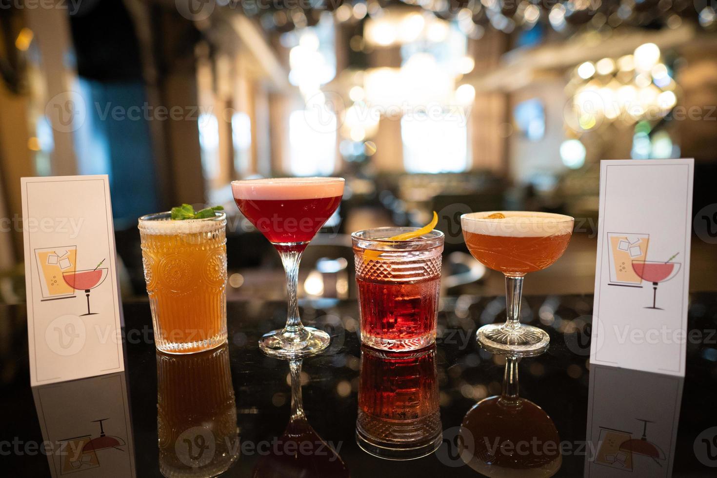 beautiful and delicious alcoholic cocktails prepared at the bar by the bartender. photo