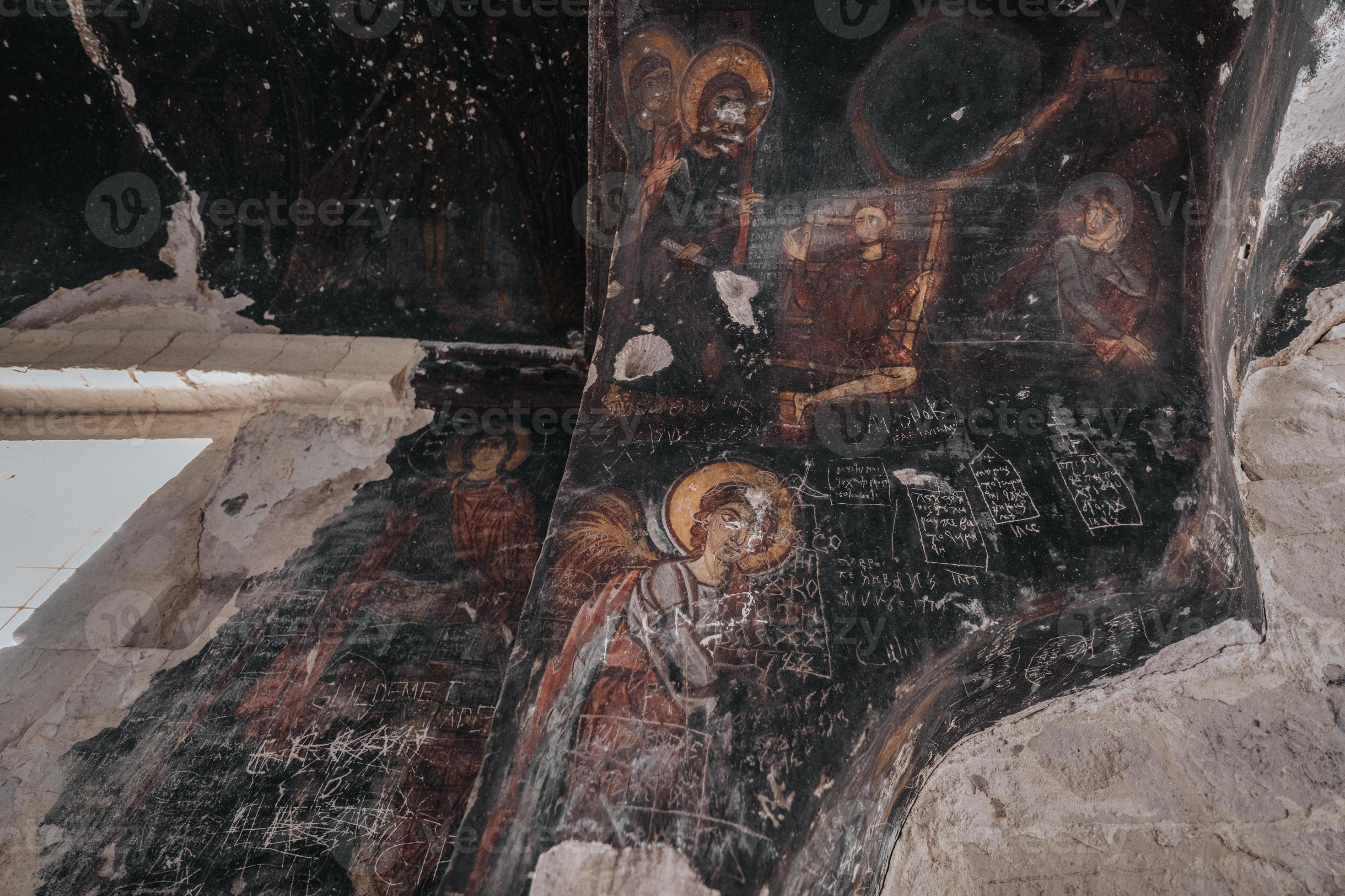A cave church in cappadocia with inscriptions on the walls frescoes