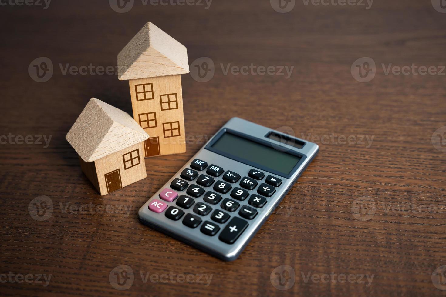 Houses and calculator. Utilities and services expenses. Taxes, home budget. Real estate valuation. Buying and selling. Building maintenance. Mortgage payments. Save money on energy efficiency photo
