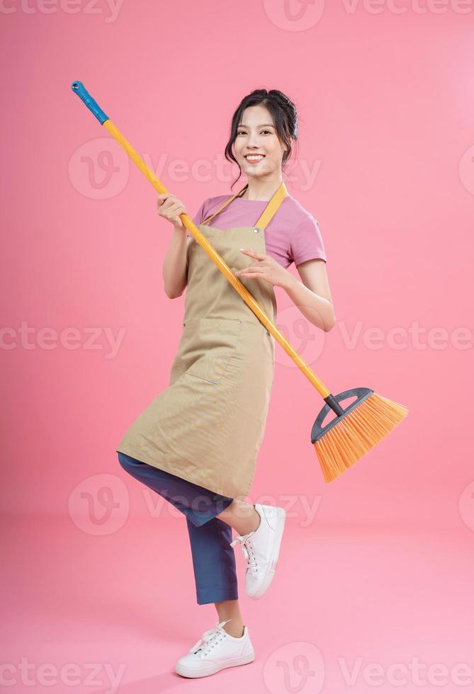 Young Asian woman housewife on background photo