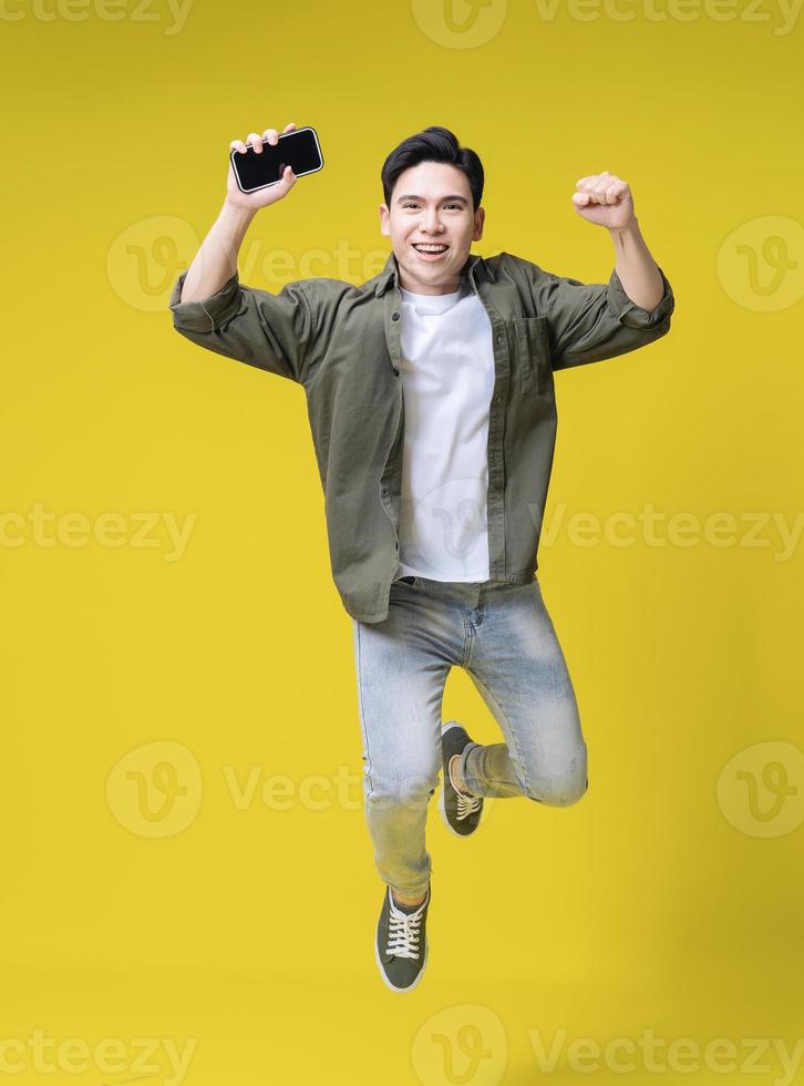 Full length image of young Asian business man standing on background photo