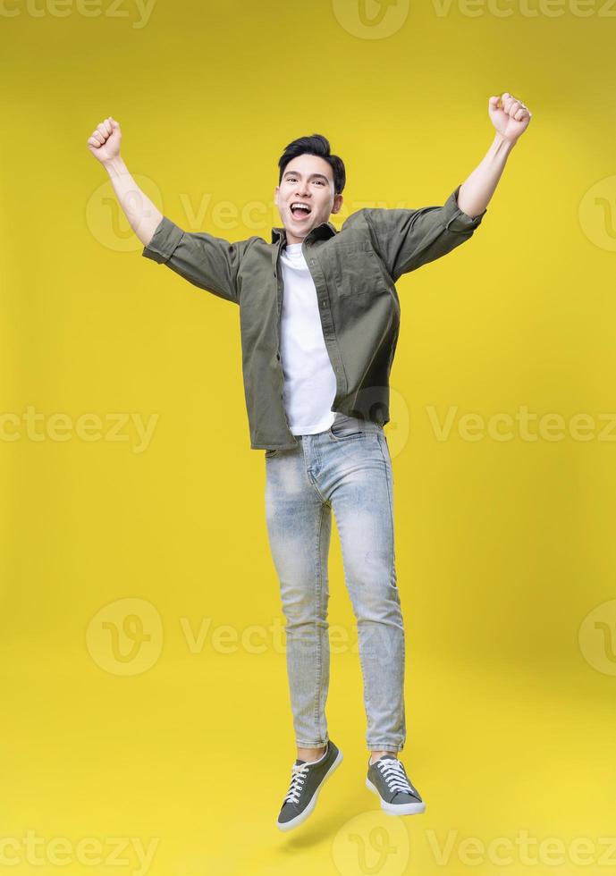 Full length image of young Asian business man standing on background photo