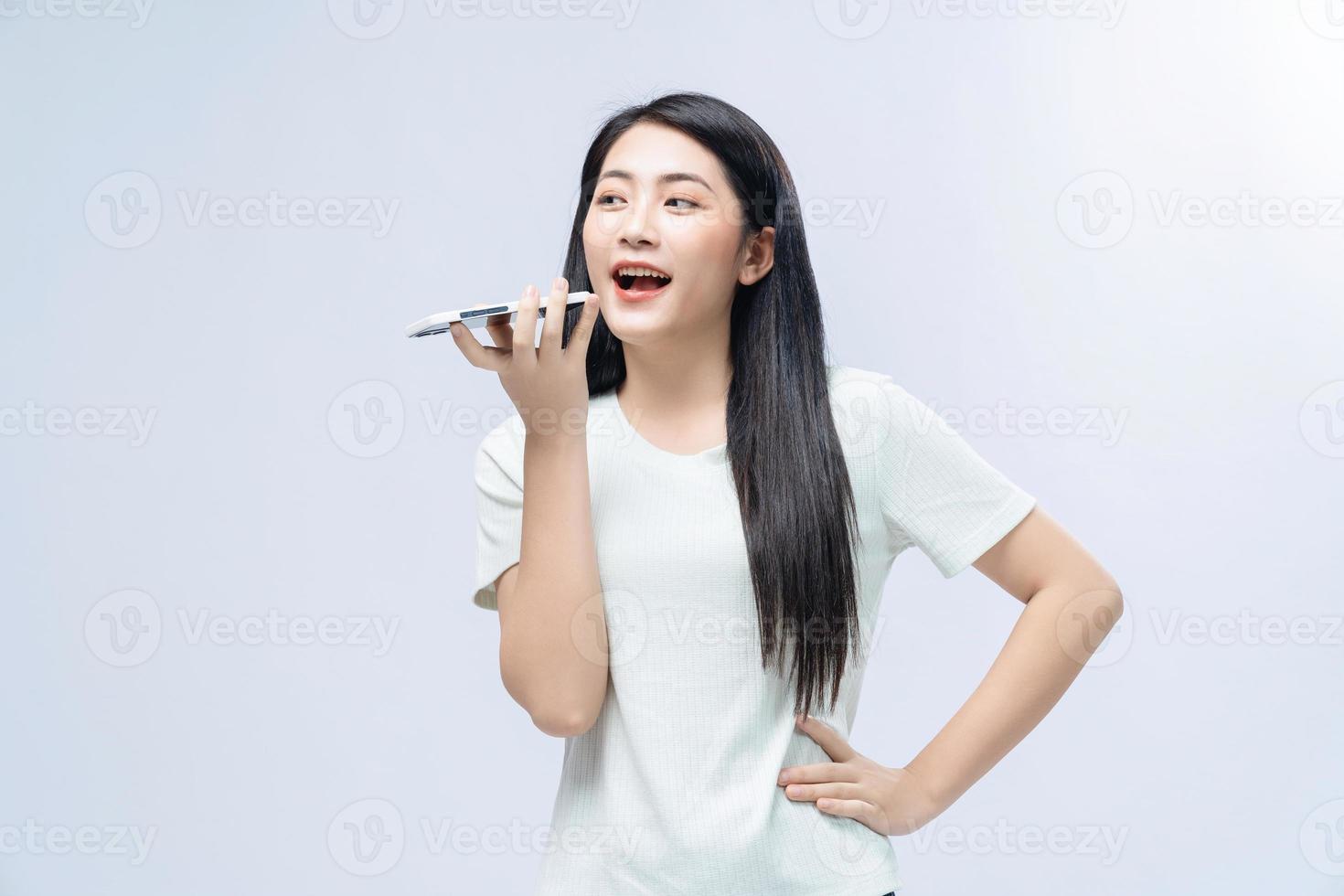 Young Asian girl using smartphone on background photo