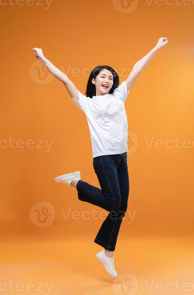 Full length image of young Asian girl on background photo