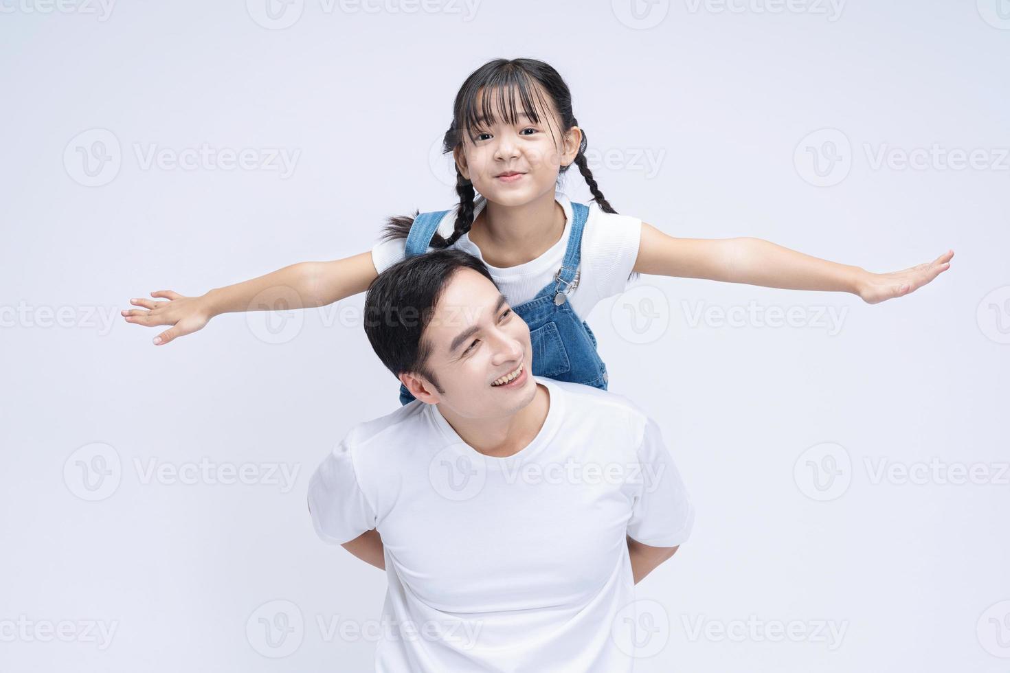 Image of Asian father and daughter on background photo