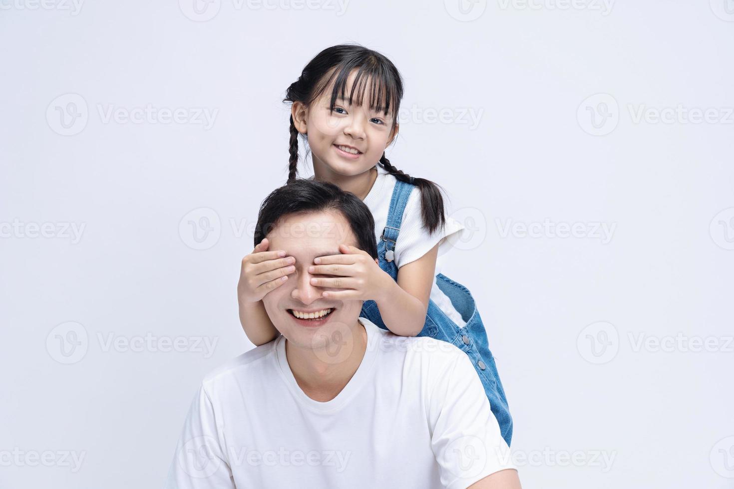 Image of Asian father and daughter on background photo