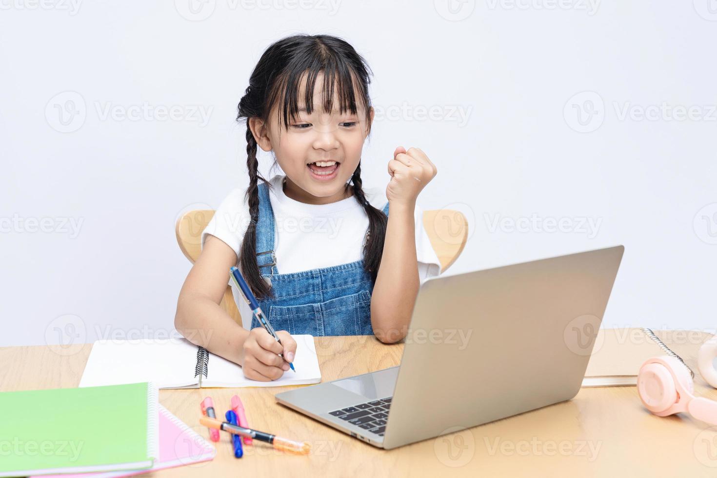 Photo of Asian kid studying on background