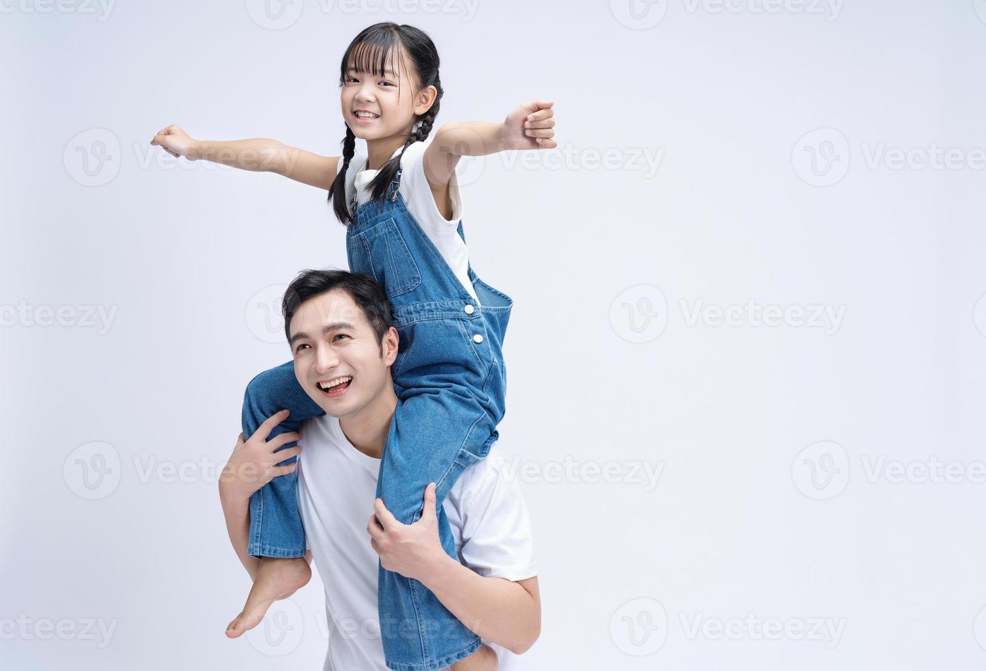 Image of Asian father and daughter on background photo