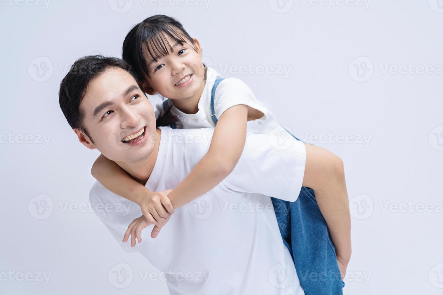 Image of Asian father and daughter on background photo